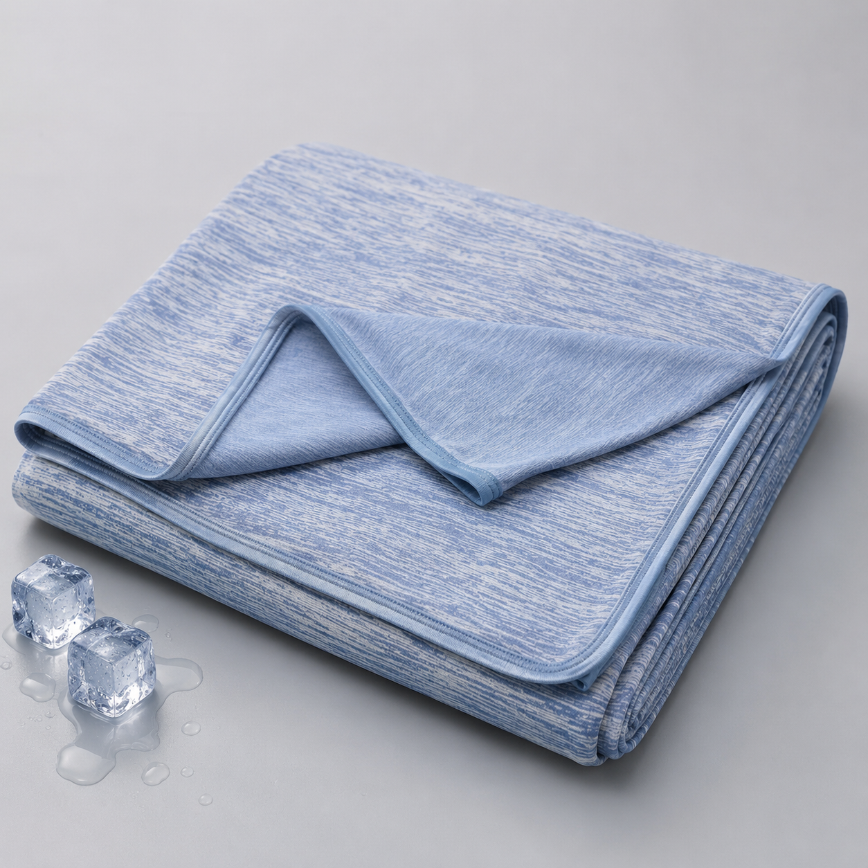 Moonchill cooling blanket in Blue Heather spread across a queen bed
