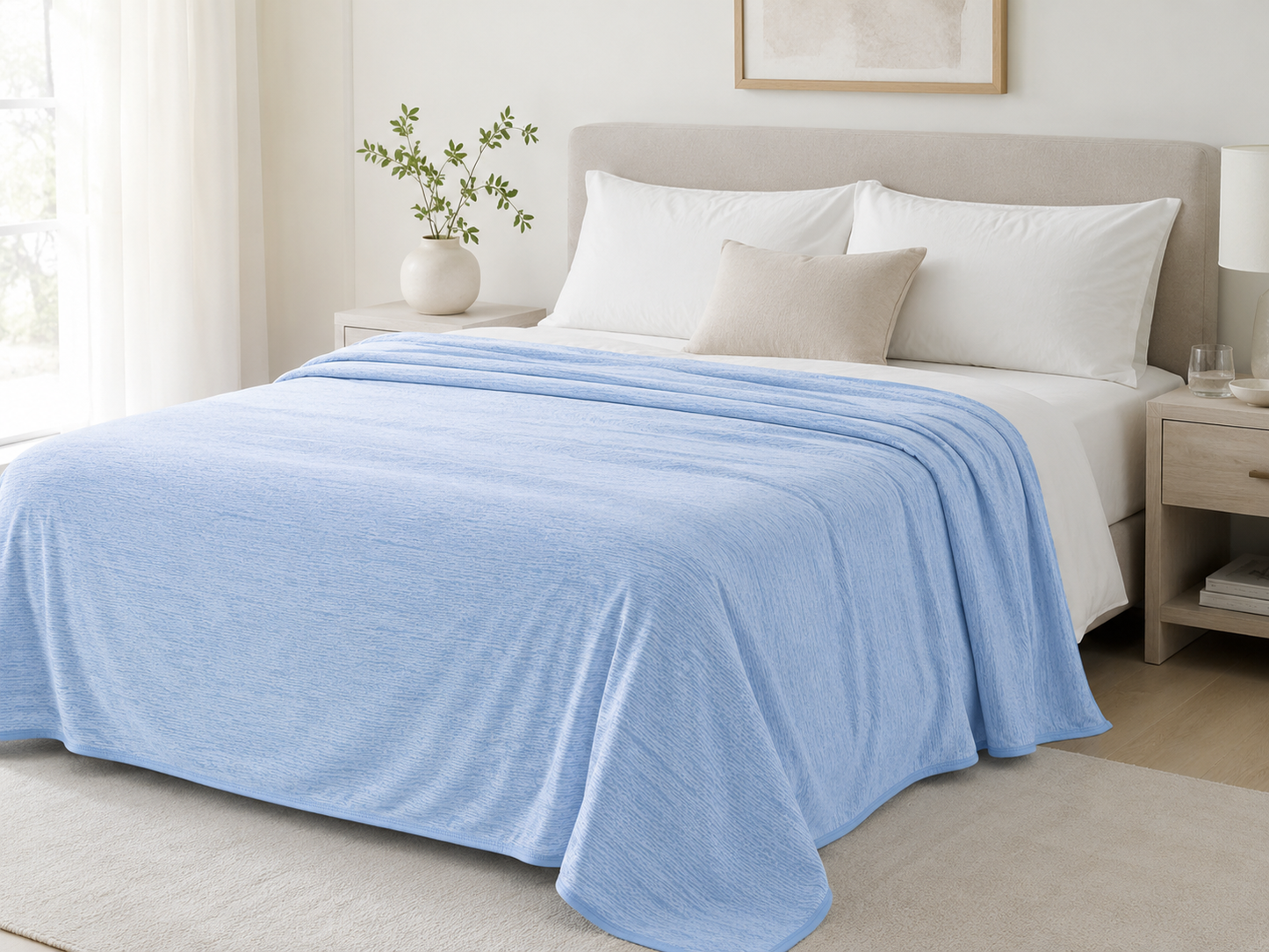 Moonchill cooling blanket in Sky Blue draped on a bed